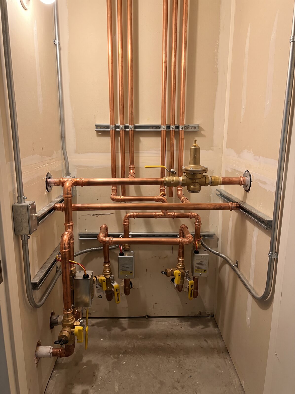 New gas and water line piping run through a utility space
