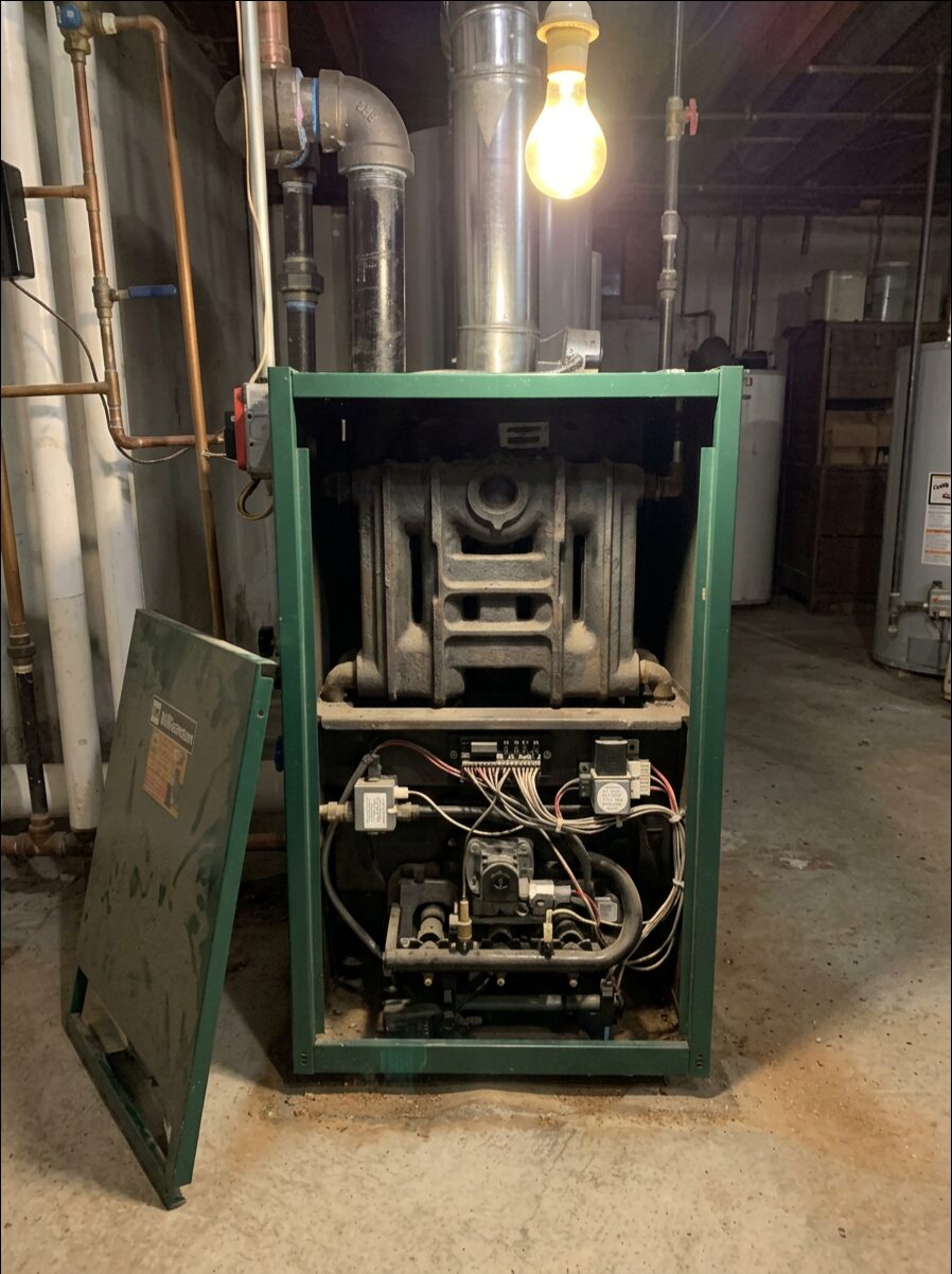 Gas boiler opened up for burner cleaning and combustion service